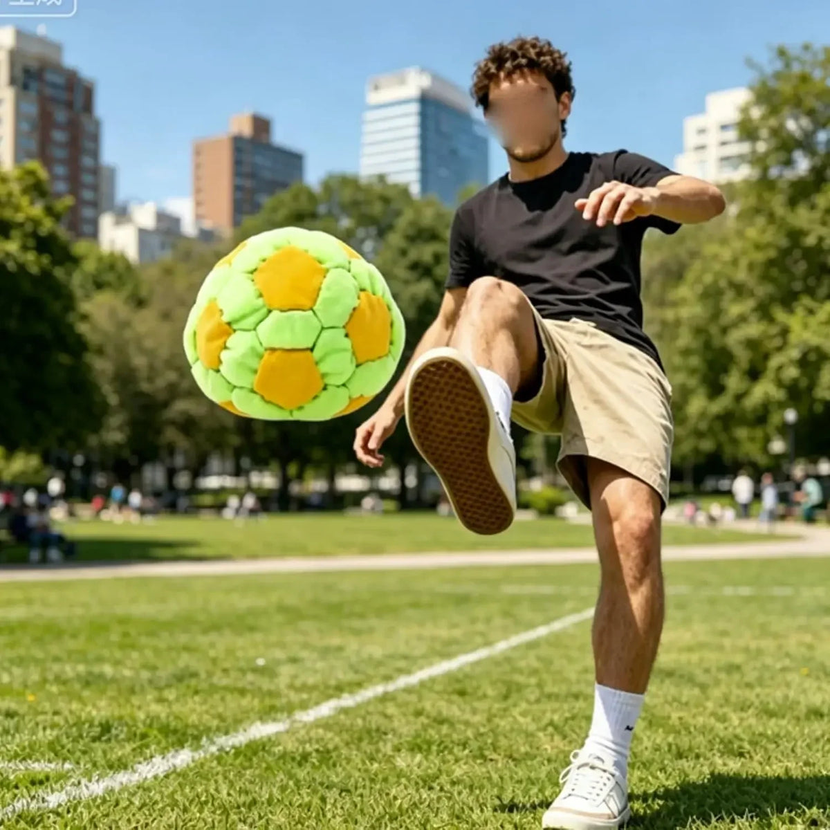 Yellow and green soccer-pattern footbag shown in an outdoor kicking scene