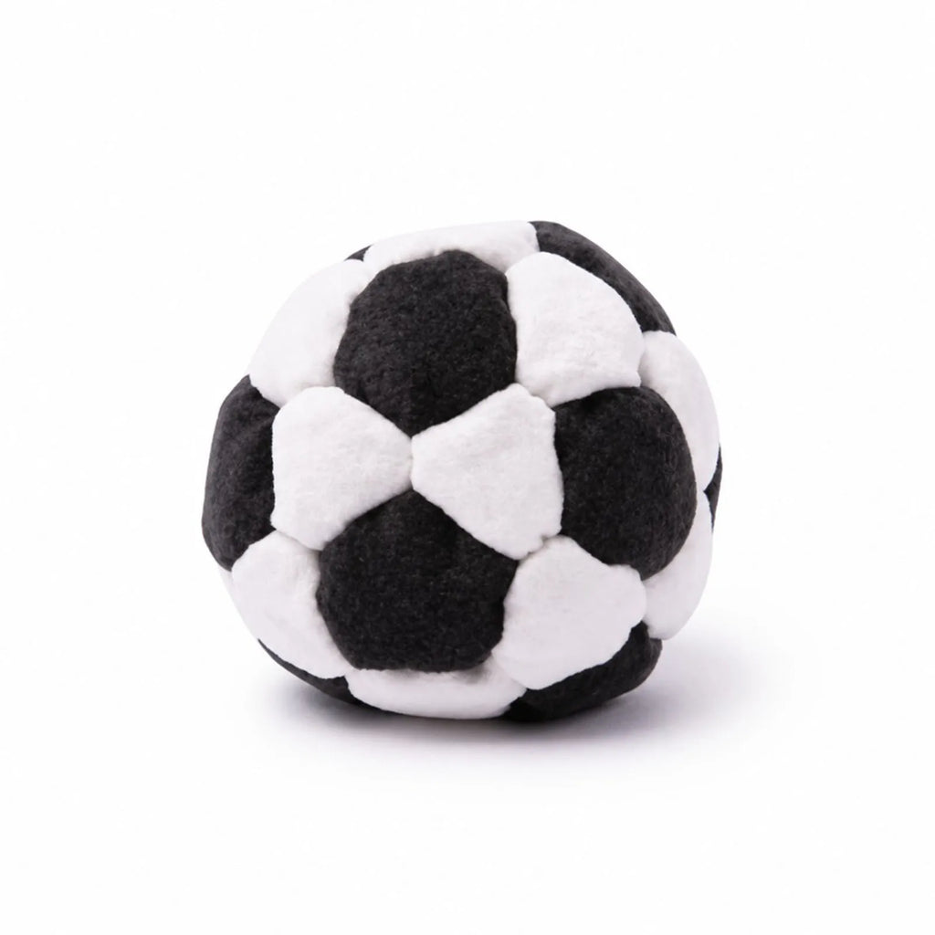 Black and white soft soccer footbag on a white background
