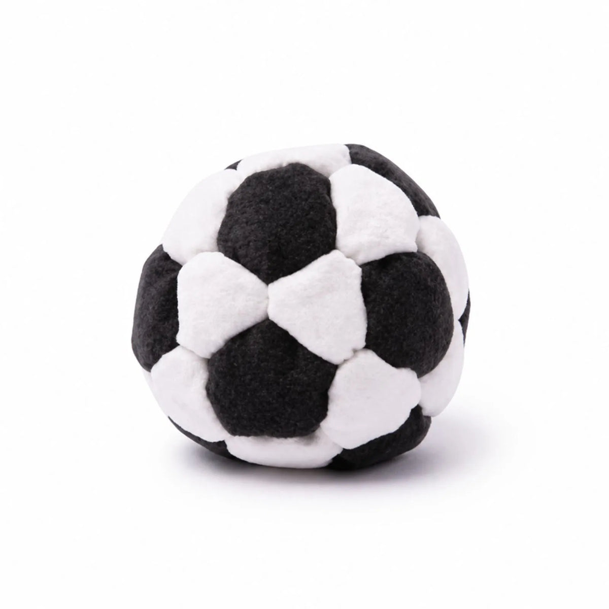 Black and white soft soccer footbag on a white background