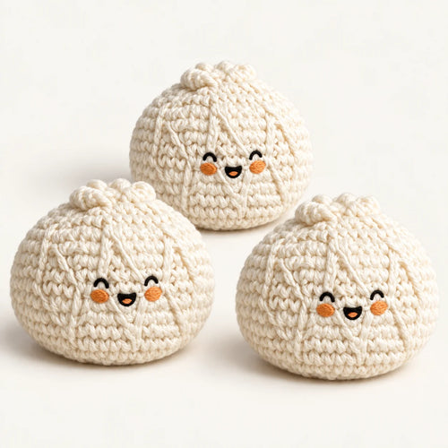Pack of three cream knitted bun footbags with embroidered smiling faces