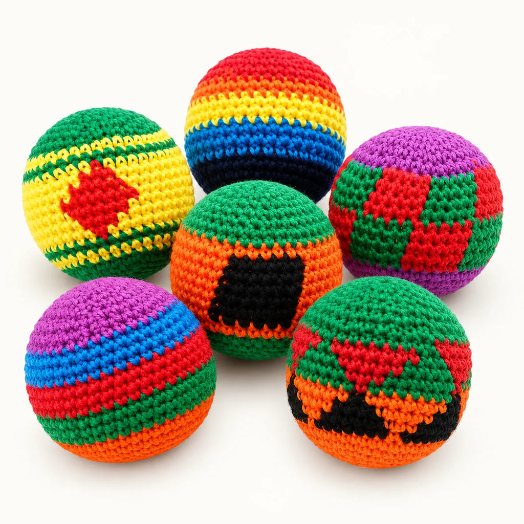 Six colorful handmade crochet footbags shown as an example assortment; colors and patterns are selected at random.