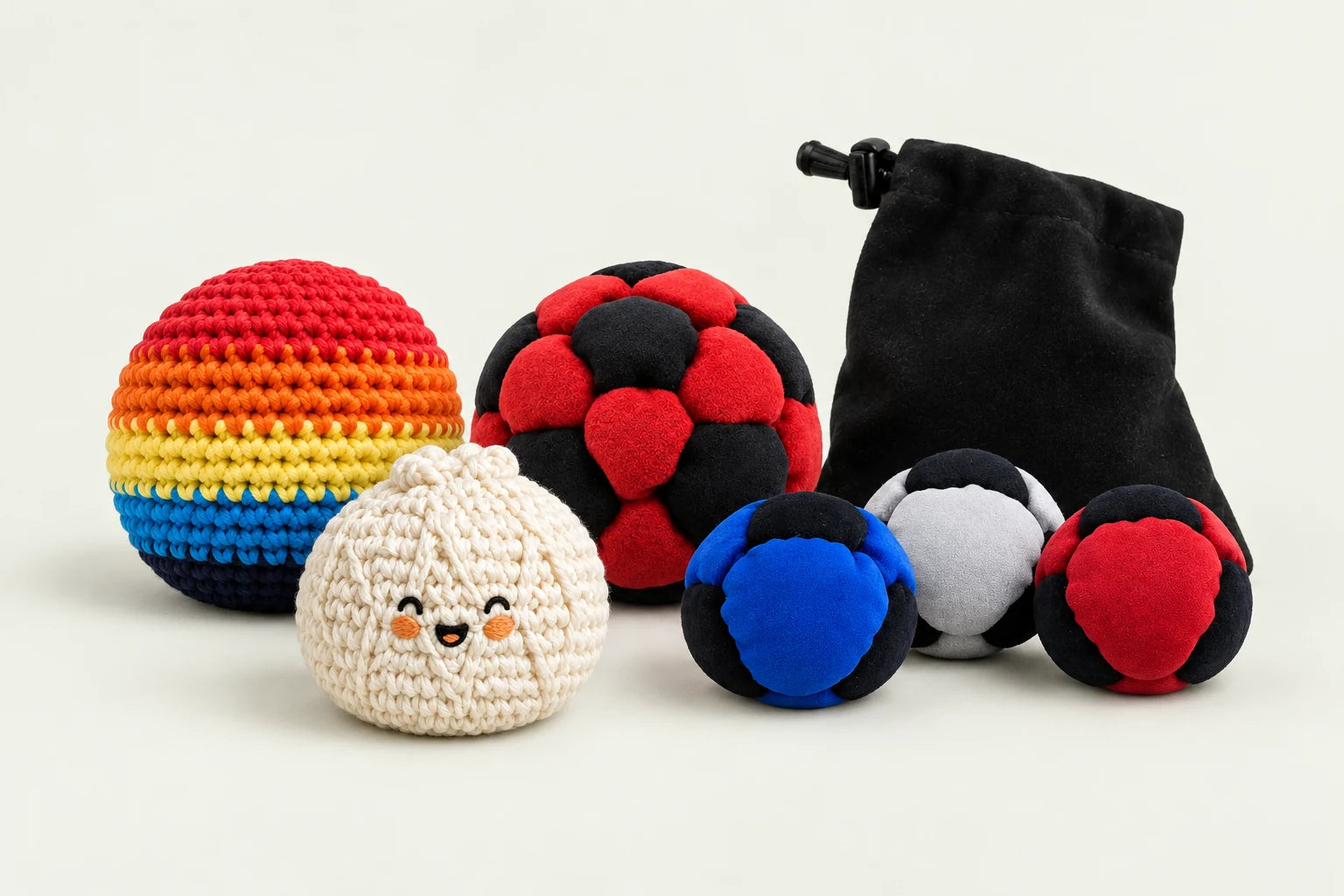 Rainbow crochet and cream knitted bun footbags beside a red-and-black soccer footbag and a three-footbag set with a black carry pouch